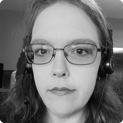 Browning Nixdorf wearing glasses and a headset and looking at the camera