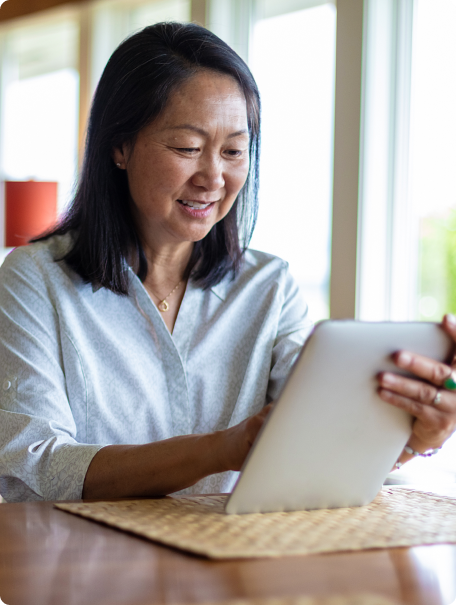 Member smiling using Thyme Care on tablet at home