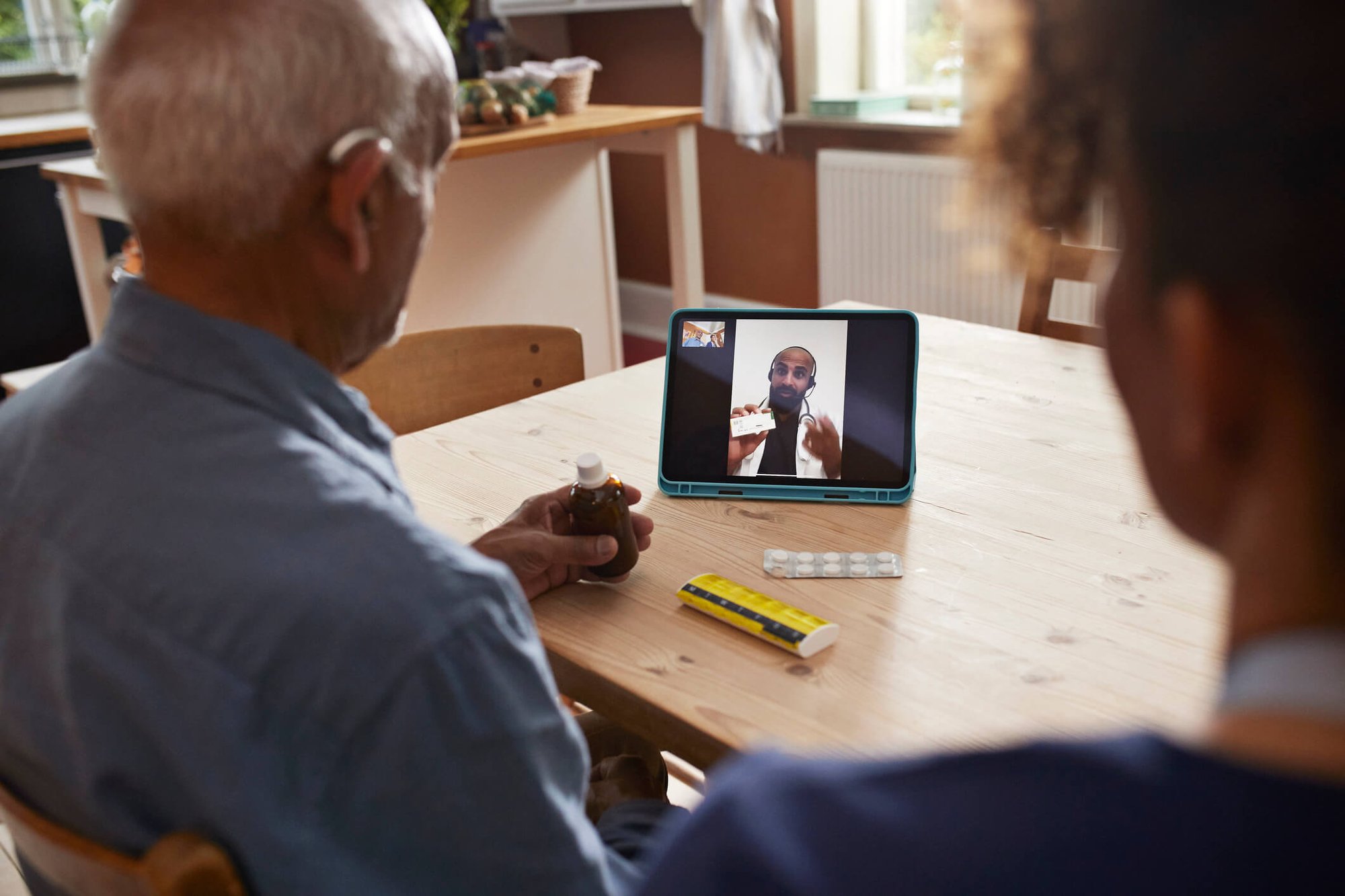 Member and family on video call with provider via tablet