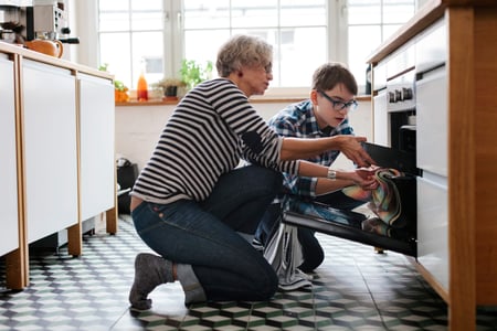 Older adult with younger child in the kitchen
