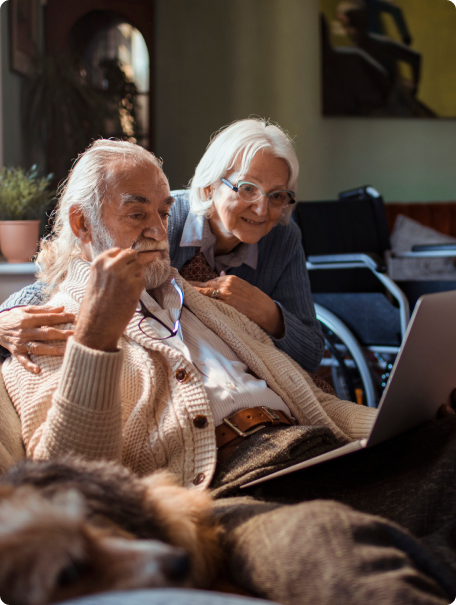 Older couple reviewing screen of laptop together