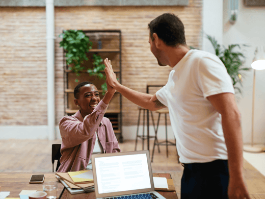 Two people high-fiving each other.